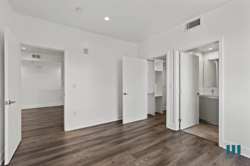 Bedroom with Bathroom, Walk-In Closet, and Vinyl Flooring