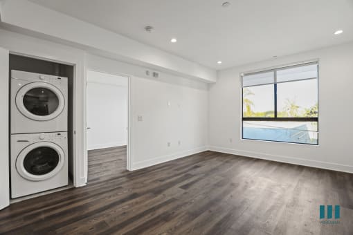 In-Suite Washer& Dryer, Living zoom with Large-Windows, Recessed Lighting, and Vinyl Flooring