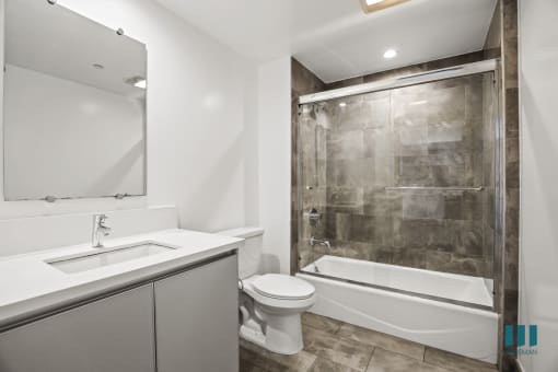 Bathroom with Shower Bath with Glass Door, and Vanity Cabinet Storage