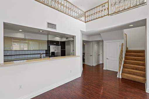 Open-Concept Kitchen and Staircase to Loft Space