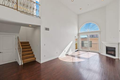 Open-Concept Dining and Living Room with Electric Fireplace and Patio