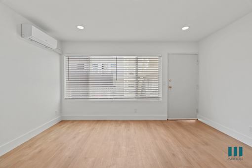 Front Entrance in Living Room with Vinyl Flooring and Large-Size Windows