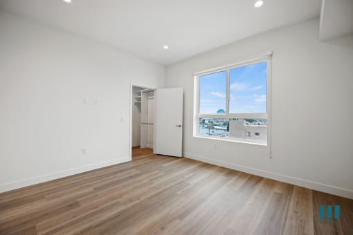 a living room with wood floors and a large window