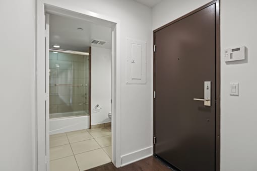 Front Door Entrance with Alarm System and a Full-Size Hall Bathroom