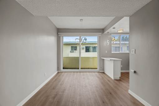 Open-Concept Kitchen, Dining, and Living Room Areas with Patio