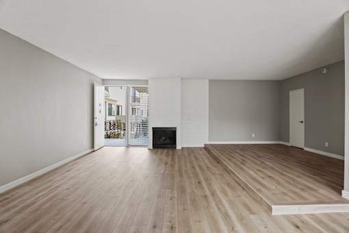 Large-Size Living Room with Electric Fireplace, Vinyl Flooring, and Patio