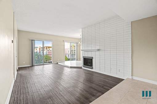 Living Room with Electric Fireplace, Vinyl Flooring, and Balcony