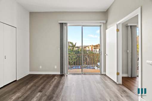 Bedroom with Closet, Balcony with Double Glass Doors, and Vinyl Flooring