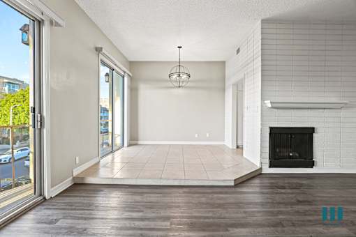 Open-Concept Living Room and Dining Room Space with Balcony and Double Glass Doors