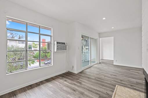 Living Room with Electric Fireplace, Recessed Lighting, Vinyl Flooring, and Patio