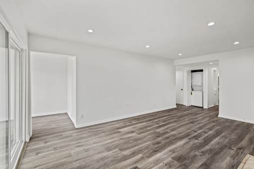 Living Room with Vinyl Flooring, Recessed Lighting. and In-Suite Washer & Dryer