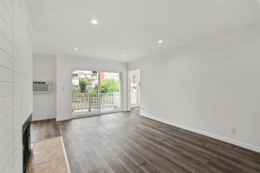Living Room with Electric Fireplace, Recessed Lighting, Vinyl Flooring, and Patio