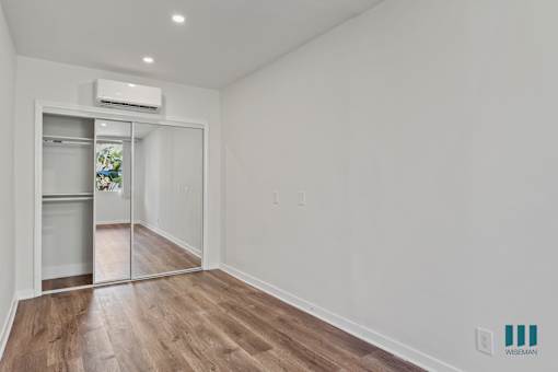 Bedroom with Mirrored Closet, Vinyl Flooring, and Recessed Lighting