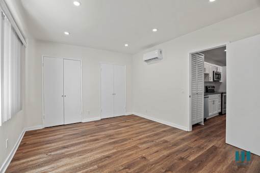 Bedroom with Multiple Closets, Vinyl Flooring, and Recessed Lighting