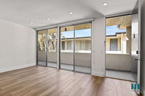 Front Entrance and Living Room with Sliding Glass Doors to Balcony