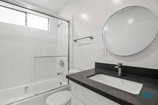 Bathroom with Shower Bath with Glass Door and Vanity Cabinet Storage