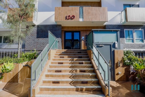 a set of stairs in front of a building with a glass door