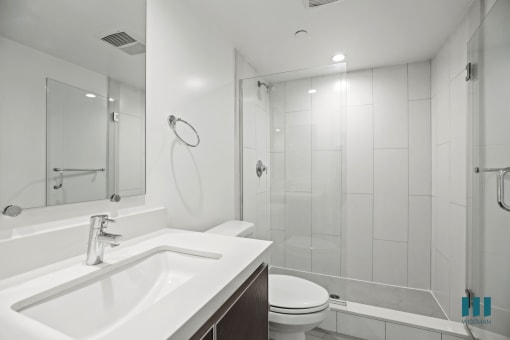 Bathroom with Walk-In Shower with Glass Door and Vanity Cabinet Storage