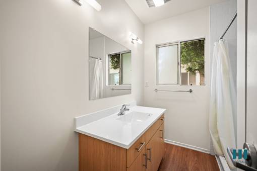 a bathroom with a sink and a mirror and a shower