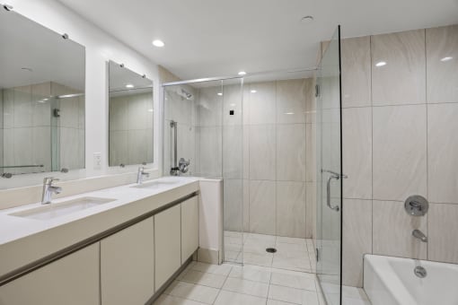 Bathroom with a Full-Size Bathtub, Shower, and Double-Sink Vanity