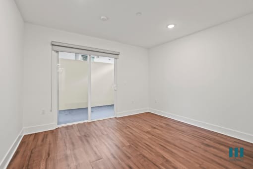 Bedroom with Vinyl Flooring, Recessed Lighting, and Patio Area