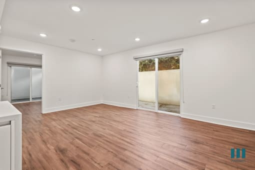 Spacious Living Room with Recessed Lighting , Vinyl Flooring, and Patio
