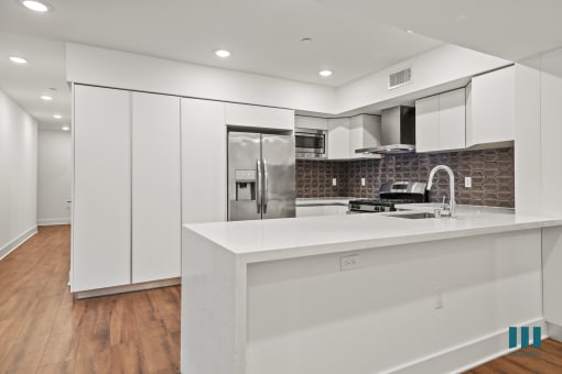 Kitchen with Pantry Cabinet Storage and Stainless-Steel Appliances
