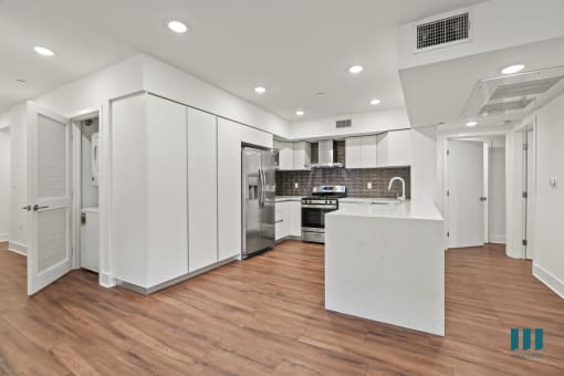 Kitchen with Energy-Efficient Appliances and Ample Cabinet Storage and Countertop Bar