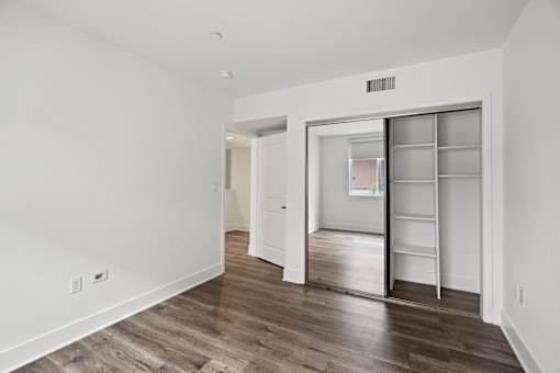 Bedroom with Mirrored Closet with Shelving