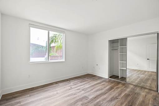 Bedroom with a Mirrored Closet and Windows