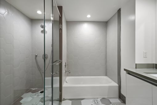 Bathroom with Bathtub and Walk-In Shower with Glass Door