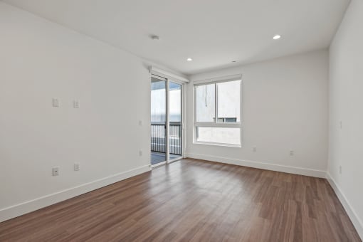 Bedroom with Recessed Lighting, Vinyl Floors, Windows, and Patio
