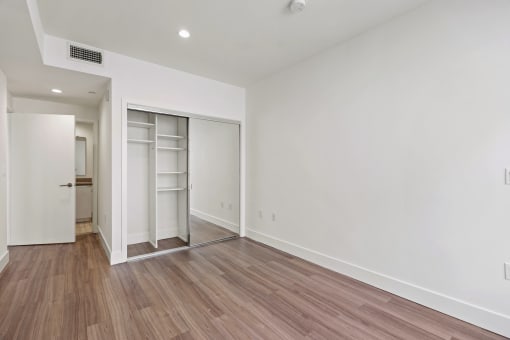 Bedroom with Mirrored Closet with Shelving