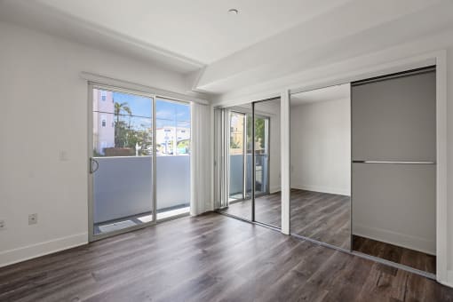Bedroom with Two Mirrored Closets and Balcony