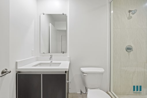 Bathroom with Walk-In Shower with Glass Door and Vanity Cabinet Storage