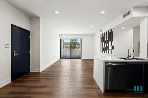 Front Entrance and Open-Concept Kitchen, Dining, and Living Room Space with Patio