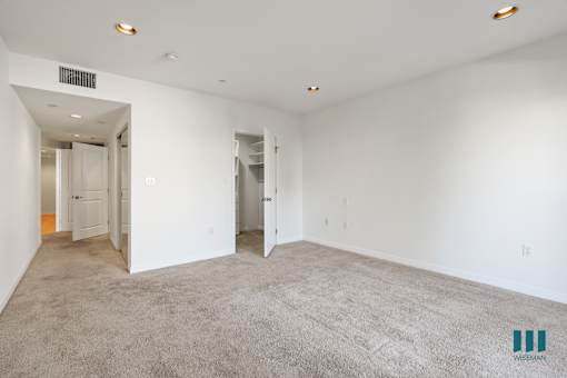 Bedroom withWalk-In Closet, Carpet, and Recessed Lighting