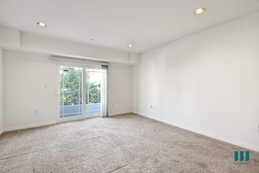 Spacious Bedroom with Recessed Lighting, Carpet, and Balcony