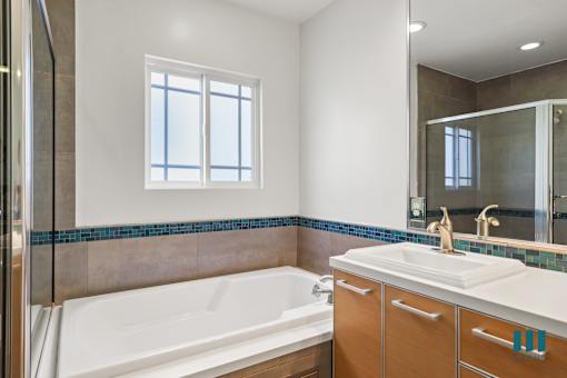 Bathroom with Full-Size Bathtub, Walk-In Shower, and Vanity Cabinet Storage