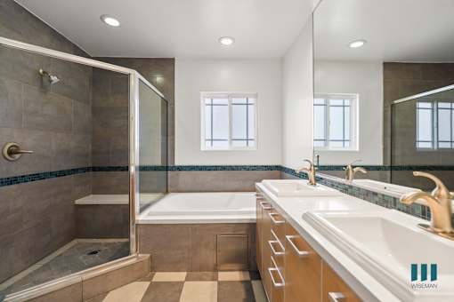Bathroom with Full-Size Bathtub, Walk-In Shower, and Vanity Cabinet Storage