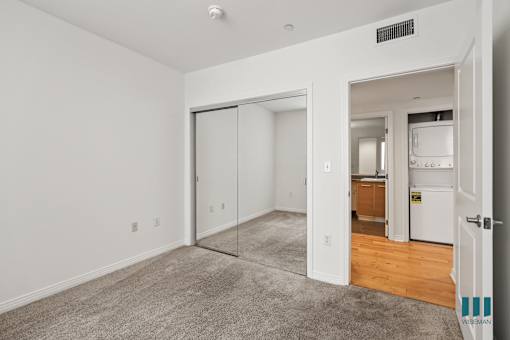Bedroom with Mirrored Closet and In-Suite Washer & Dryer