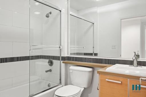 Bathroom with Shower Bath with Glass Door and Vanity Cabinet Storage