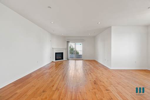 Open-Concept Dining and Living Room Areas with Electric Fireplace, Vinyl Flooring, and Patio