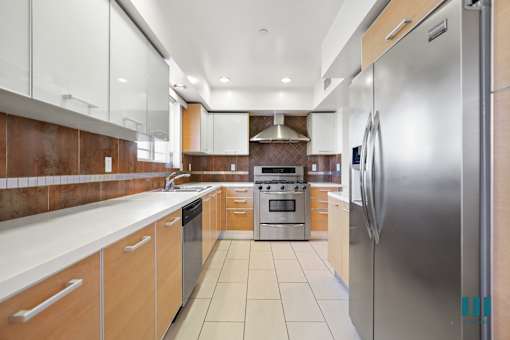 Large-Size Kitchen with Stainless-Steel Refrigerator, Stove, Microwave Oven, and Dishwasher