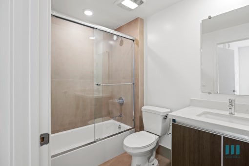 Bathroom with Shower Bath with Glass Door and Vanity Cabinet Storage
