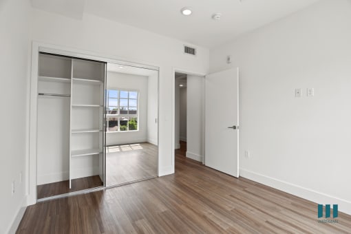 Bedroom with Mirrored Closet with Shelving