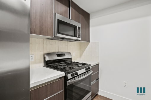 Kitchen with Stainless Refrigerator, Stove, and Microwave Oven