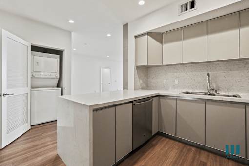 Kitchen with Countertop Bar and In-Suite Washer & Dryer