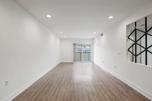 a bedroom with a medium sized bed and a doorway into a room