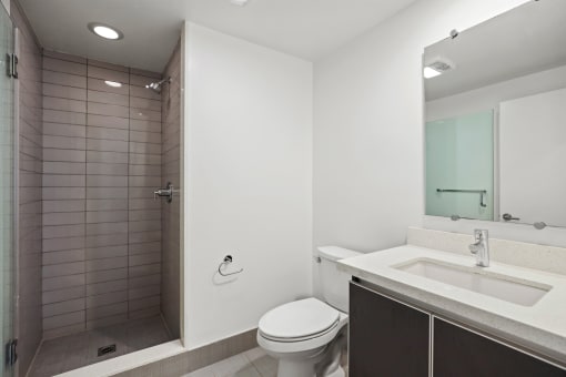 a bathroom with a toilet sink and shower